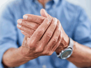 Man rubs his arthritic hands.