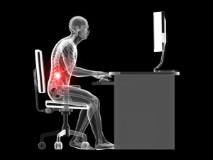 Image emphasizing office worker's skeletal system as they sit at a desk working with a computer screen