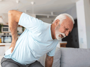 Older man with sciatica clutches back