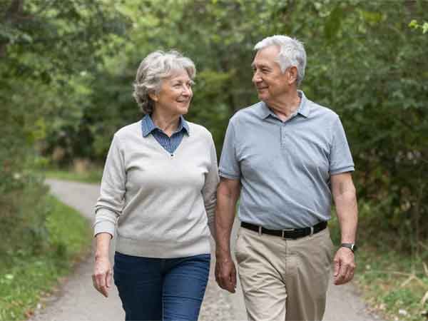 older couple walking in woods