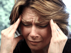 Woman suffering from chronic migraine headache.