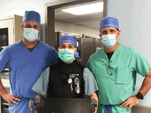 Dr. Jeffrey Rowe, MD (center) stands between two colleagues after completing the first Spinal Simplicity G3 procedure in Pennsylvania.